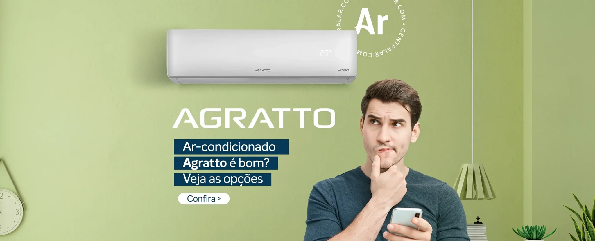 Man looking at his phone thoughtfully while standing below an Agratto wall-mounted air conditioner.